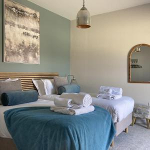 una camera con due letti con asciugamani di Blue Iris Cottage, Ashlin Farm Barns a Lincoln