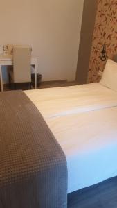a bedroom with a bed with a blue light on it at Hotel B&B Sint-Maria NEXT DOOR in Valkenburg