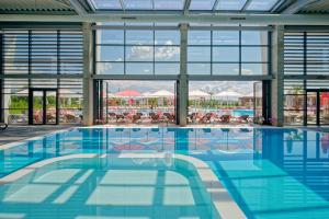 a swimming pool with a view of a resort at Terme di Hissar Camping in Hisarya