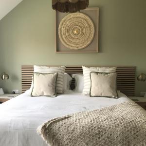 a bedroom with a large bed with white sheets and pillows at Chestnut House, Ashlin Farm Barns in Lincoln