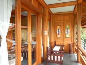 a room with two chairs and a table in a building at Villa Dua Bintang in Munduk