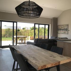 a living room with a wooden table and chairs at White Swan Cottage, Ashlin Farm Barns in Lincoln