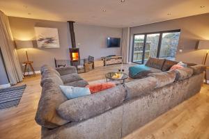 a large living room with a large couch at Holly Tree Barn, Ashlin Farm Barns in Lincoln