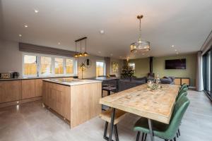 a kitchen and dining room with a wooden table at The Hazels, Ashlin Farm Barns in Lincoln