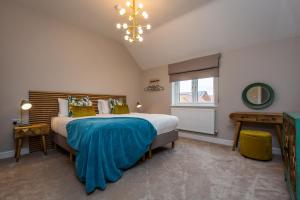 a bedroom with a large bed and a window at The Pines, Ashlin Farm Barns in Lincoln