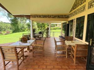 a patio with tables and chairs on a house at Farm Cottage in Mukono
