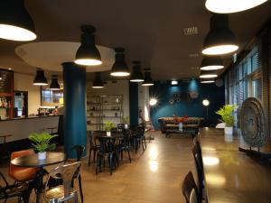 a restaurant with tables and chairs and a couch at Hotel La Meridiana in Perugia