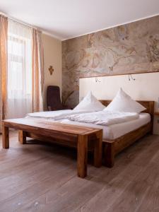 a bedroom with a large bed with a wooden frame at Kloster Bonlanden in Berkheim