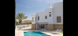 a house with a swimming pool in front of it at Mojacar Apartment Near the Beach with Private Pool in Mojácar
