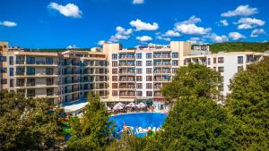 a view of a hotel with a swimming pool and trees at Prestige Hotel and Aquapark - All inclusive in Golden Sands