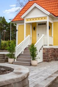 a yellow house with an orange roof at Trädgårdsmästarbostaden / The Gardeners Villa in Gävle