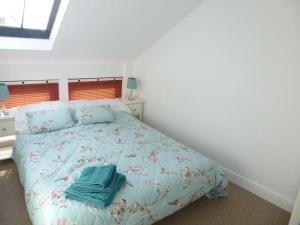 a bedroom with a bed with blue towels on it at The Stables, Lower Mill Estate in Somerford Keynes