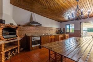 a kitchen with a wooden table and a brick wall at Porto Residence Campanhã in Porto