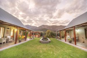 an outdoor patio with a view of the mountains at Mirihof Retreat and Olive Estate in Montagu