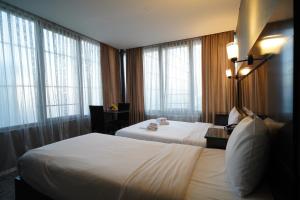 a hotel room with two beds and windows at Espinas Hotel in Istanbul