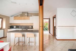 una cucina con bancone e due sgabelli di Villa Vista Lago di Como by villavistalago a Bellano
