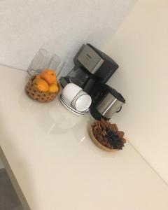 a coffee maker and some fruit on a counter at Bardy guest house in Chʼiva