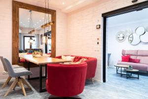 a living room with a red couch and a table at Hotel-Restaurant Sebastianushof in Bonn