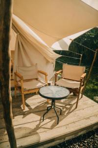 百度庫的住宿－Alamu Eco Lodge，一张桌子、两把椅子和一个帐篷
