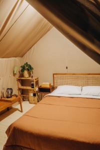a bedroom with a bed in a tent at Alamu Eco Lodge in Bedugul