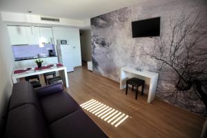 a living room with a couch and a table at Apartments Villa Tomislav in Brela