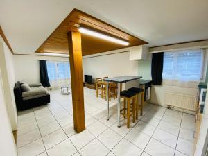 a kitchen and living room with a table and chairs at Matten Central Residences in Matten