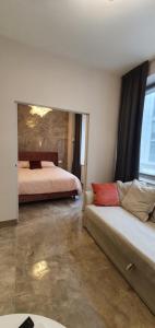 a bedroom with a bed and a couch in a room at Pink Maison Milano Centro Piazza Diaz Duomo in Milan