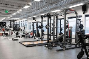 a gym with a lot of treadmills and machines at Olympiatoppen Sportshotel - Scandic Partner in Oslo