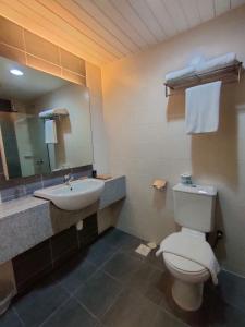 a bathroom with a toilet and a sink and a mirror at Pavilion Fahrenheit 88 Bukit Bintang 3 bedrooms in Kuala Lumpur