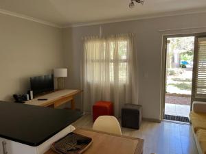 a living room with a desk and a computer in it at Happy Home Rondebosch in Cape Town