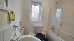 a bathroom with a sink and a toilet and a shower at Graylingwell! 4/5Bedroom House Chichester Goodwood in Chichester +8 photos