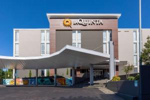 a building with a sunitta sign on the front of it at La Quinta Inn & Suites by Wyndham Tulsa Downtown - Route 66 in Tulsa