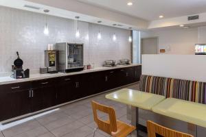 a large kitchen with a counter and a table at La Quinta Inn & Suites by Wyndham Tulsa Downtown - Route 66 in Tulsa