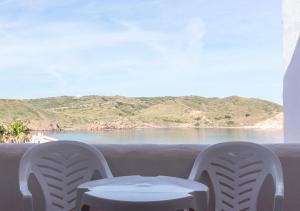 a table and two chairs and a view of the ocean at Comitas Tramontana Park in Fornells