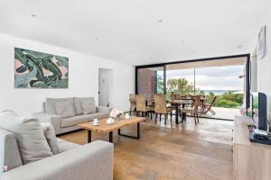 a living room with a couch and a table at Villa Rosa in Punta Prima
