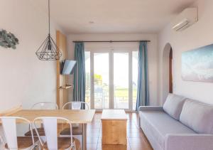 a living room with a couch and a table at Comitas Tramontana Park in Fornells