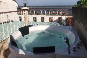 a jacuzzi tub on top of a balcony at AmazINN Places Private Rooftop and Jacuzzi IX in Panama City
