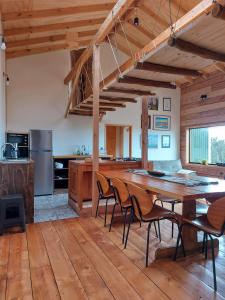 a large kitchen with a wooden table and chairs at Casa Puente de Chiloé in Castro