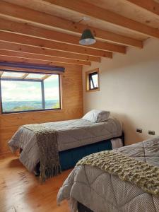 Postel nebo postele na pokoji v ubytování Casa Puente de Chiloé