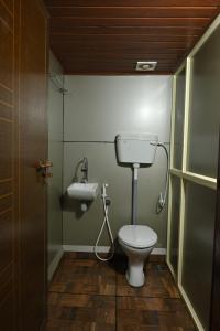 a bathroom with a toilet and a sink at Anandavana Jungle Living By LexStays - Kanthalloor-Marayur in Kanthalloor +42 photos