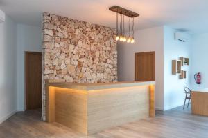 a stone wall in a room with a counter at Comitas Tramontana Park in Fornells