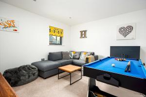 a living room with a couch and a pool table at Family friendly property in nature reserve The Hangout ML15 in Somerford Keynes