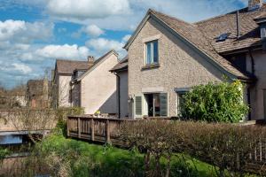 a house with a wooden deck in the yard at Family friendly property in a nature reserve The Mallards MV53 in Somerford Keynes