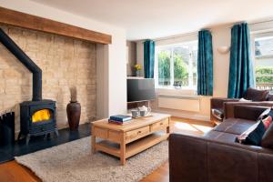 a living room with a fireplace and a couch at Family friendly property in a nature reserve The Mallards MV53 in Somerford Keynes