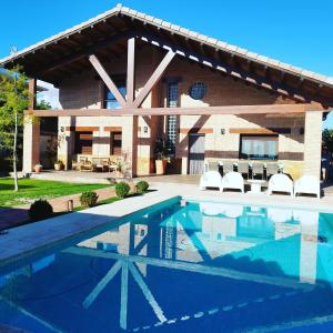 a house with a swimming pool in front of a house at Mi lugar favorito in Torrejón del Rey