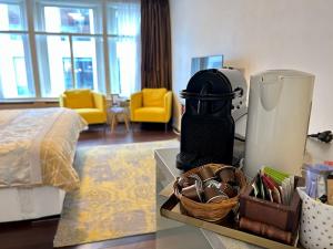 a room with a bed and a table with a coffee maker at Amsterdam 4 Holiday GuestRooms in Amsterdam
