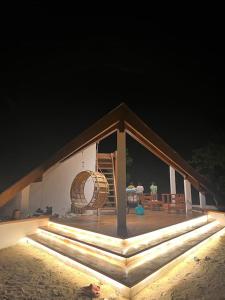 una casa con una terraza con una silla y una mesa en Private beachfront villa en Roxas