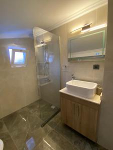 a bathroom with a sink and a shower at Shared Pool Flat Located 3 Min to Beach in Kalkan in Kalkan