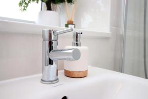 a bathroom sink with a chrome faucet at Stylish modern retreat overlooking Poole Quay in Poole