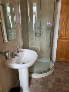 a bathroom with a sink and a shower at Glenarroch & Witchwood in Kyleakin